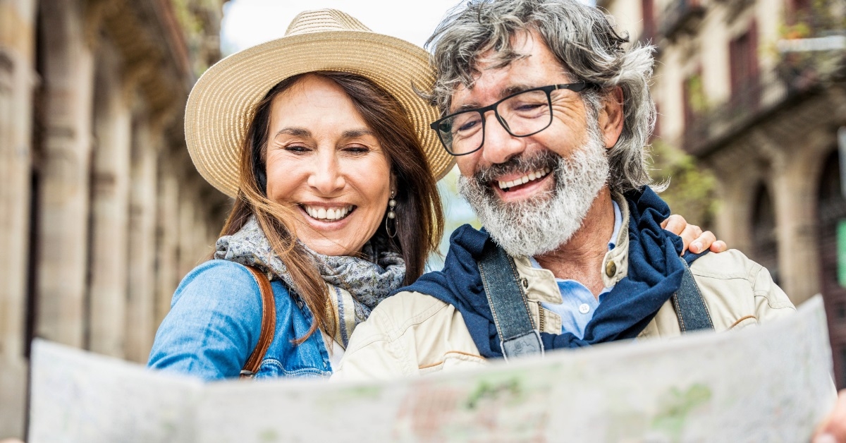 senior couple reviewing map while traveling