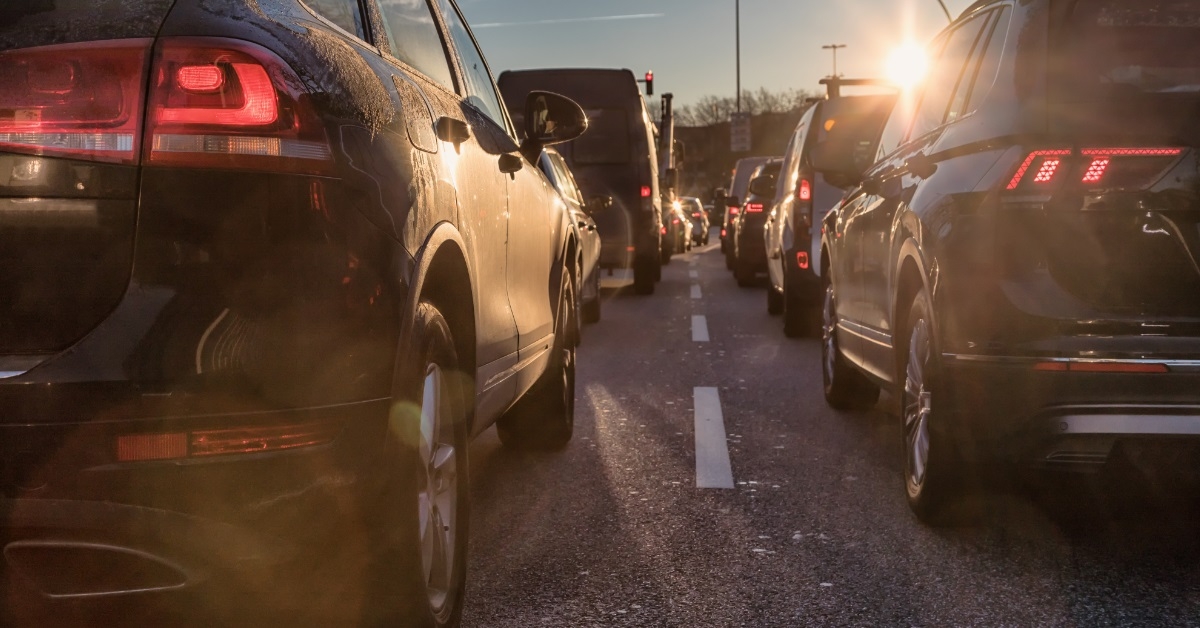 suv waiting in traffic at sunset