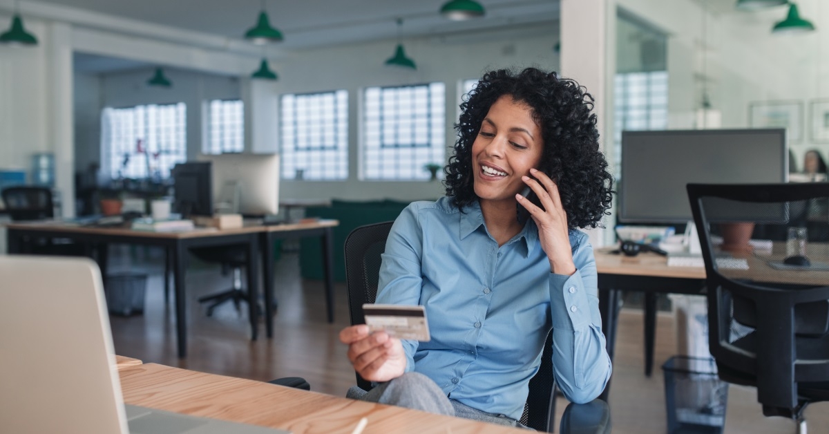 businesswoman using card on phone
