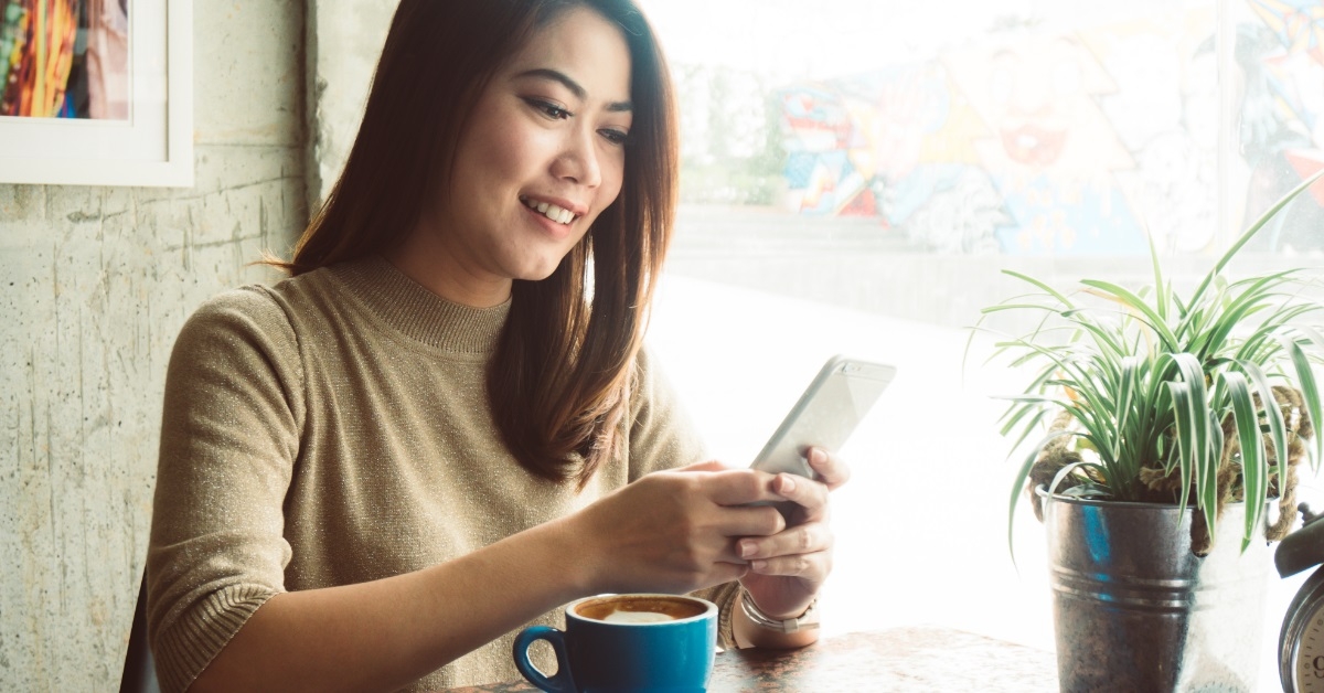 woman using smartphone at coffee shop