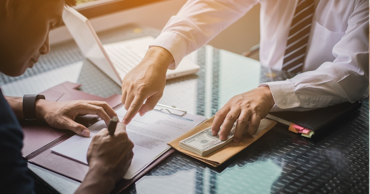 investor signing documents with male client