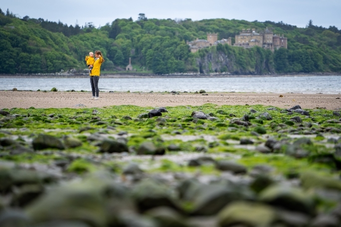 A woman and toddler on a beach in Scotland