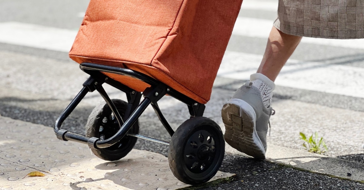 senior woman carrying trolley bag