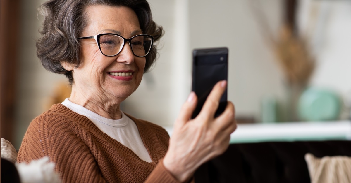senior woman using smartphone at home