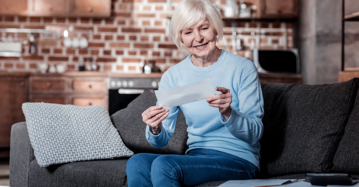 senior woman reviewing bills at home