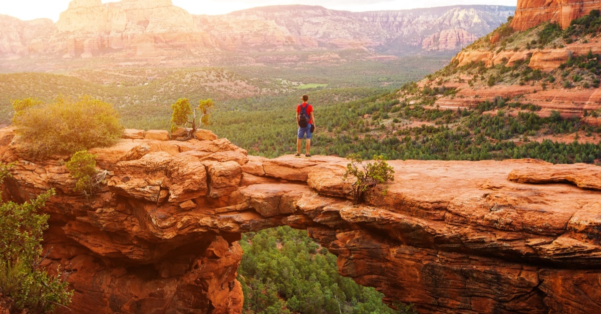 man hiking on devil's bridge trail
