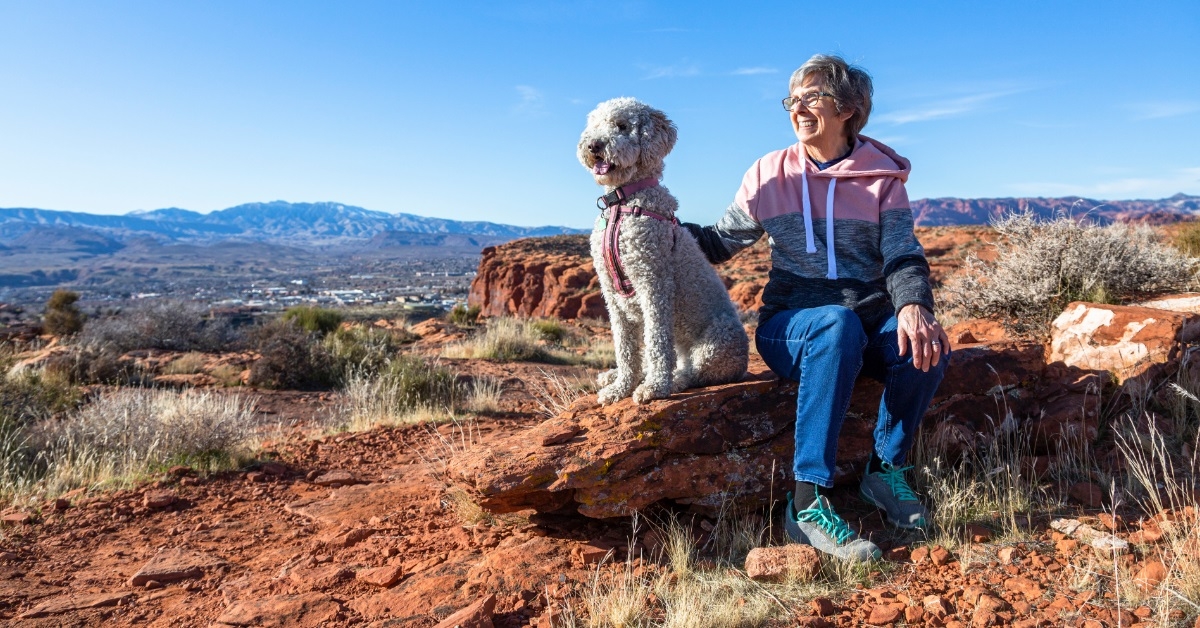 senior woman hiking with dog