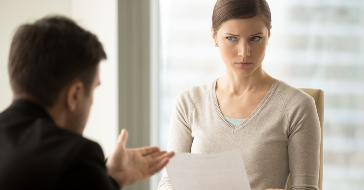 businessman scolding female candidate