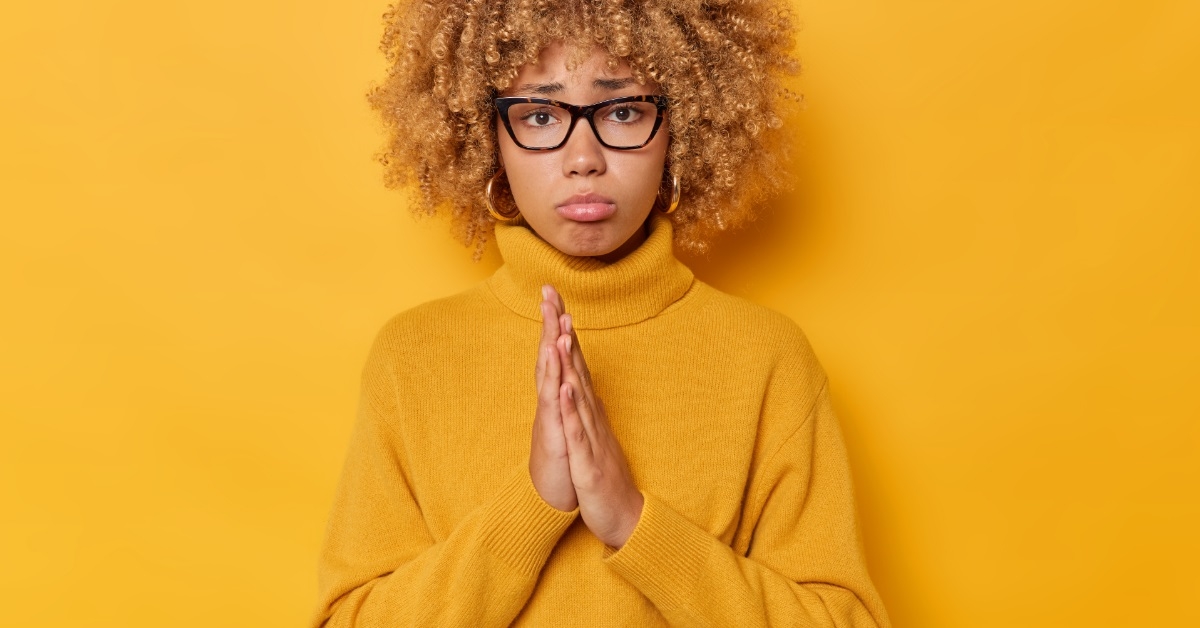 depressed woman rubbing palms