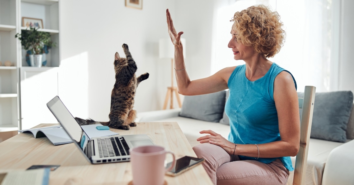 woman with cat working from home