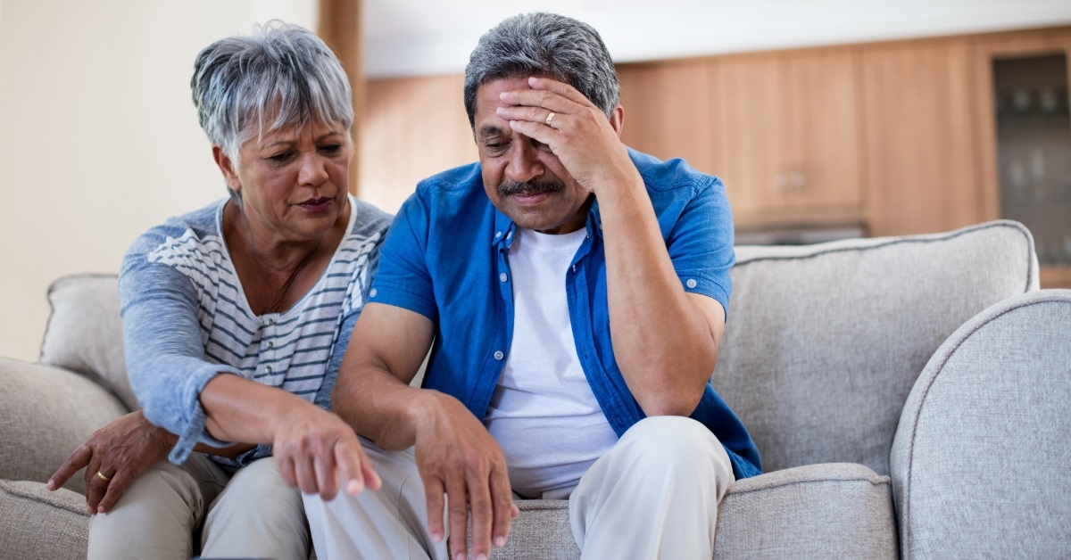 stressed senior couple reviewing bills