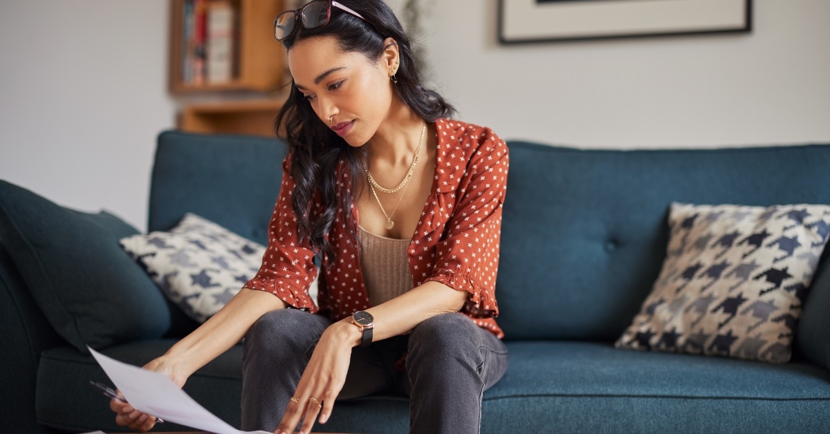 attractive woman reading bills at home