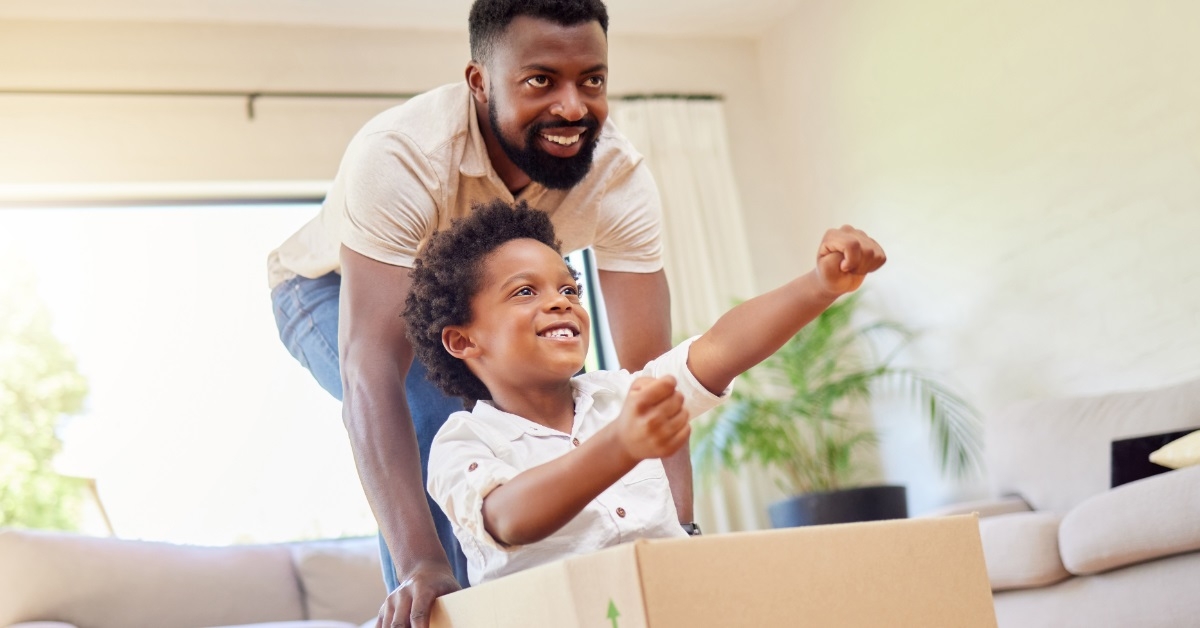 father son playing with moving boxes