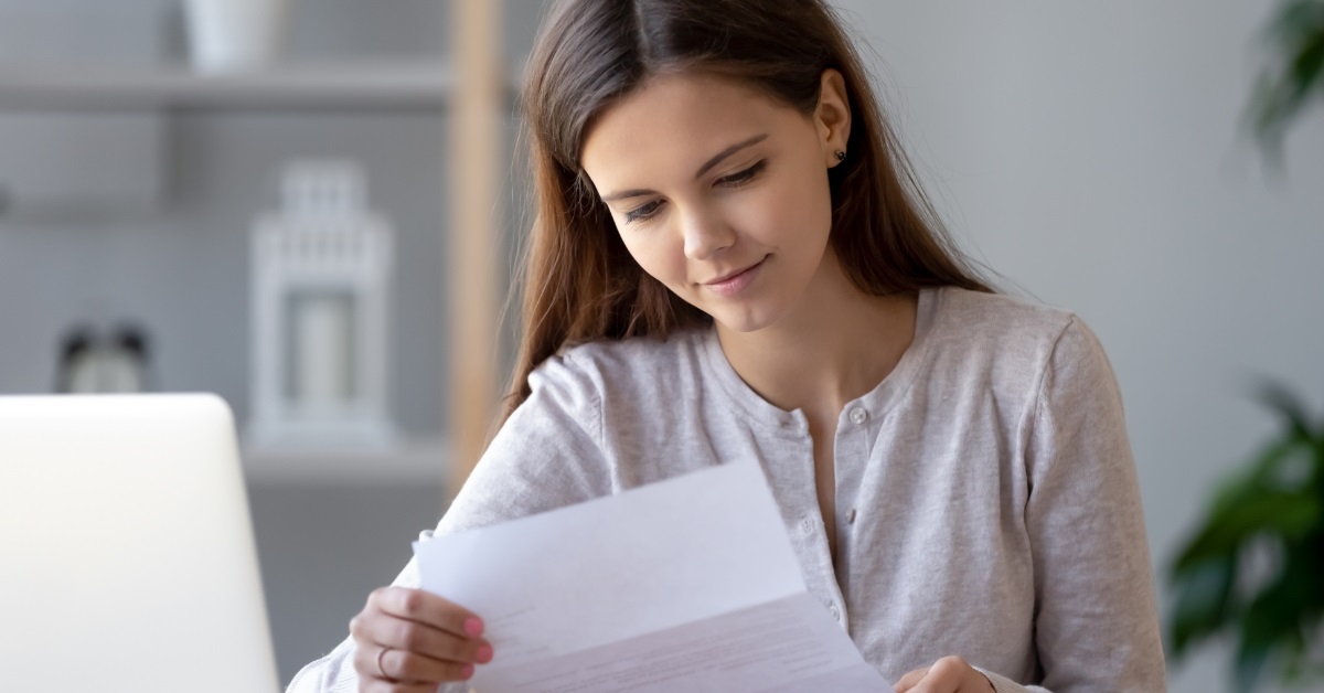 woman reviewing bills while working
