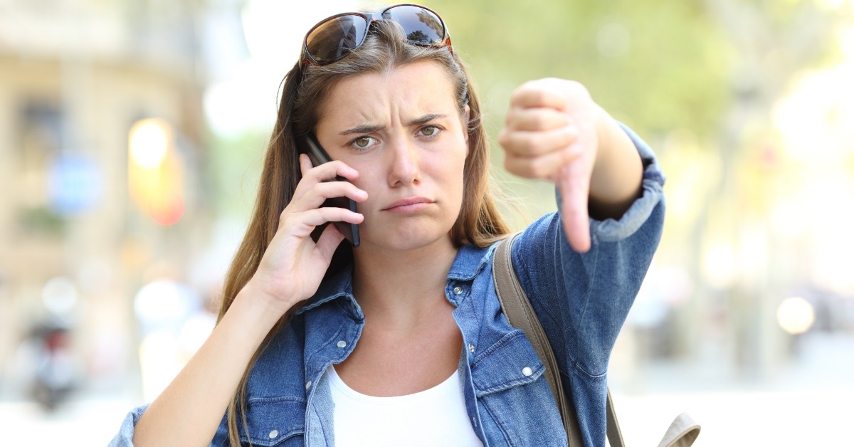 woman on call doing thumbs down 