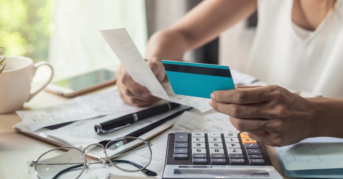 woman paying bills using card