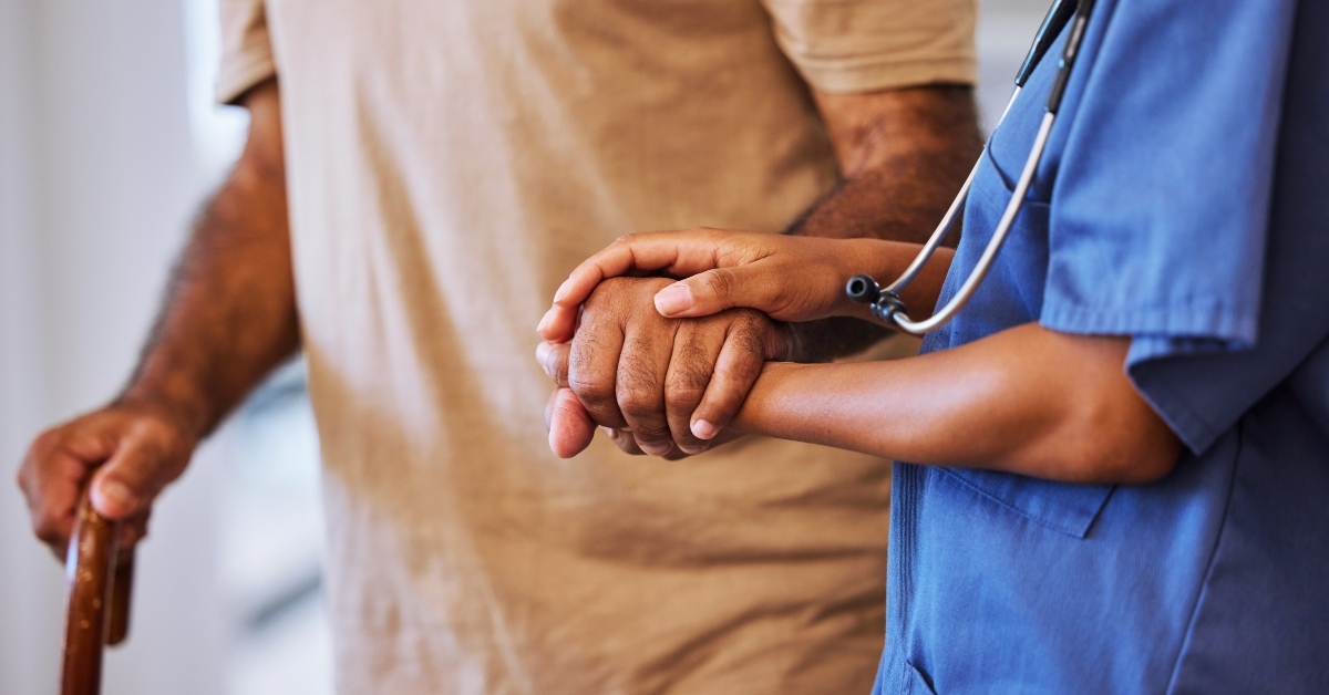 nurse walking with senior man