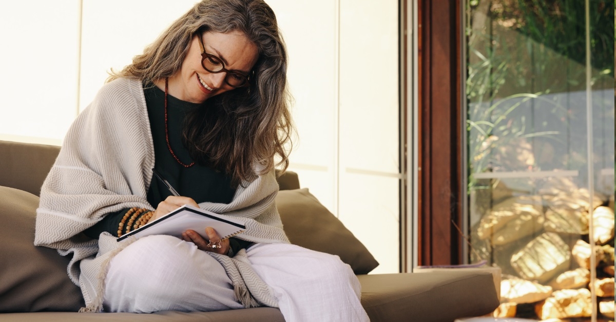 stylish senior woman journaling on notebook