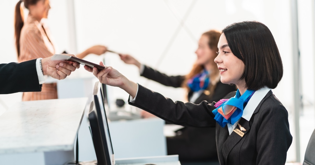 female airport ground staff checking passport