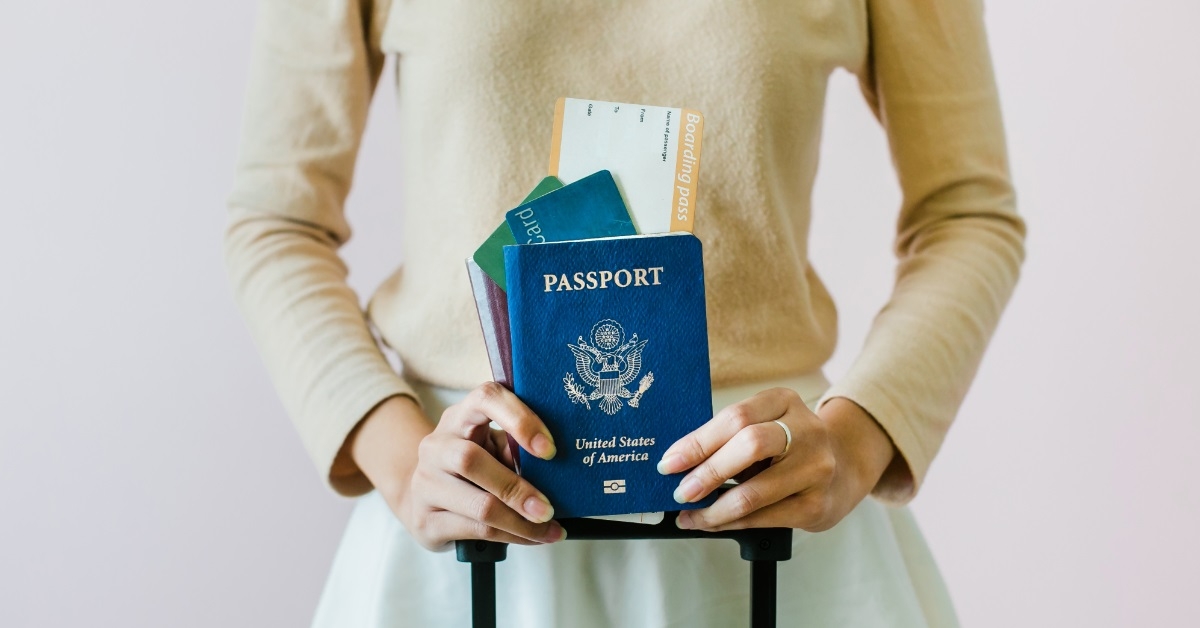 girl holding boarding pass with passport