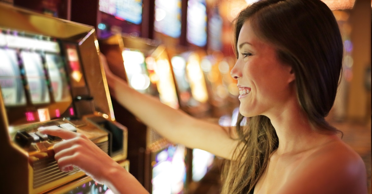 asian woman playing on slot machine
