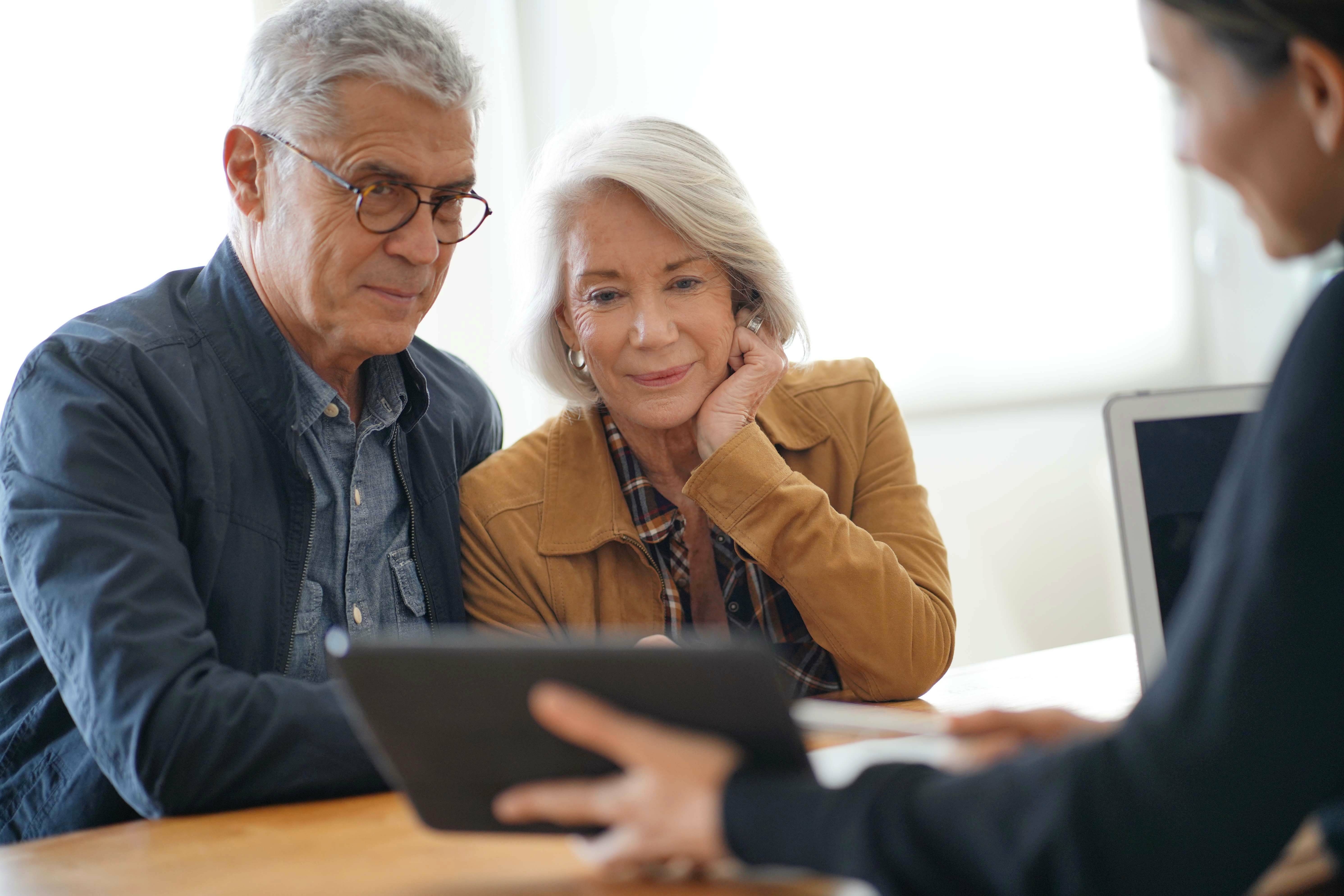 senior couple remodeling ideas on tablet