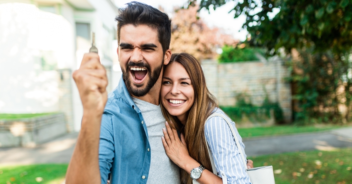 couple in front of their new home