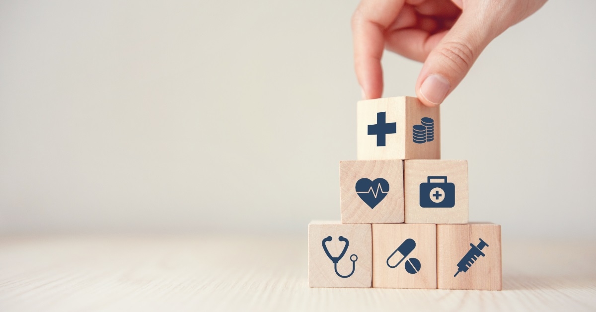 hand arranging healthcare wooden cubes