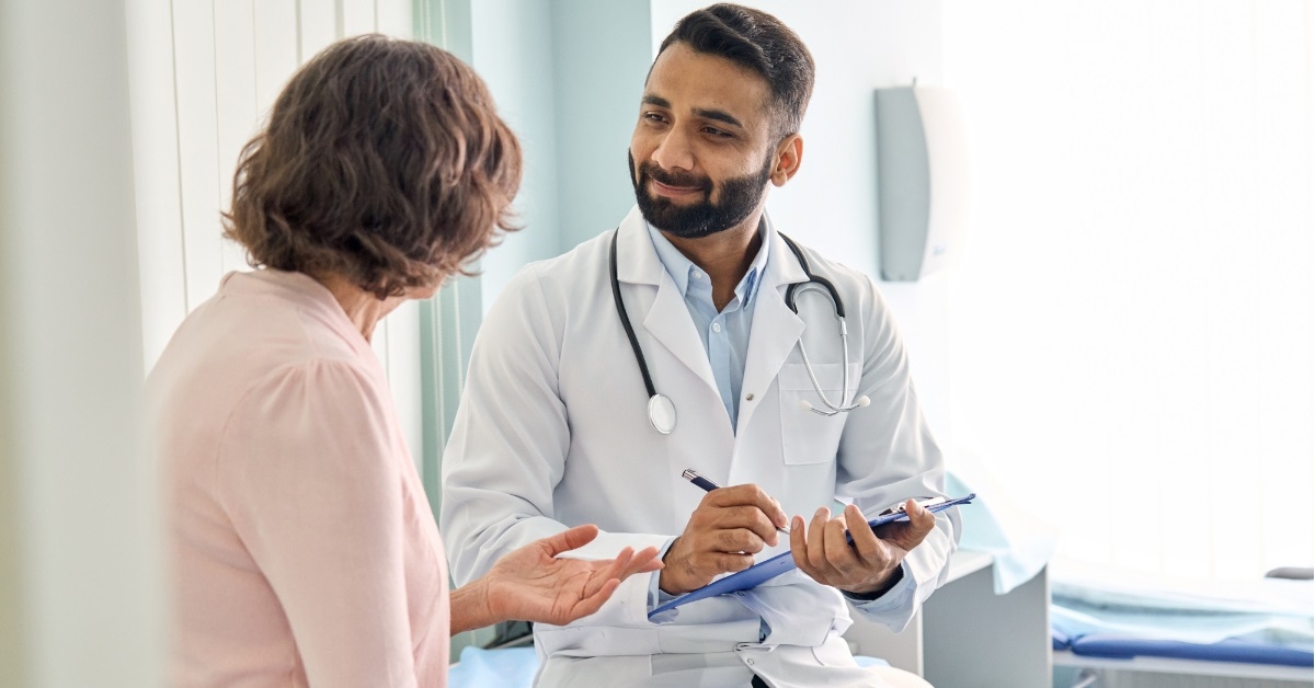 senior female patient consulting male doctor