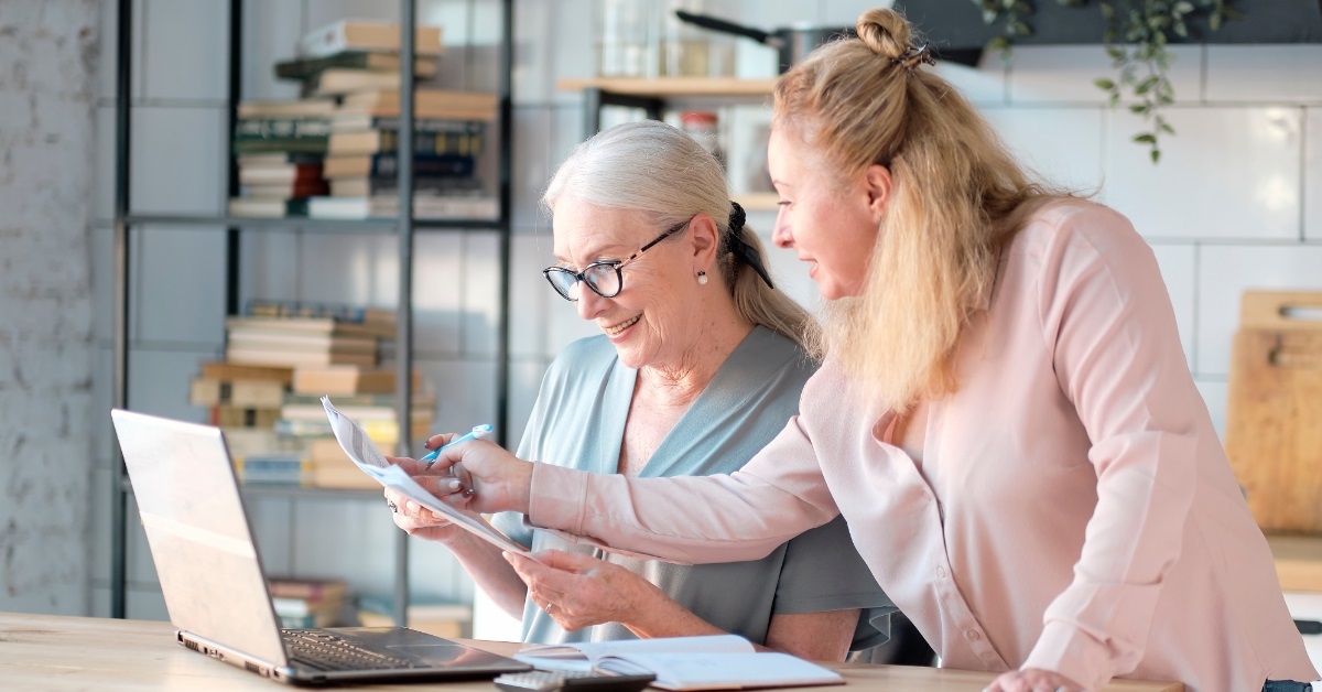 senior woman using laptop with daughter