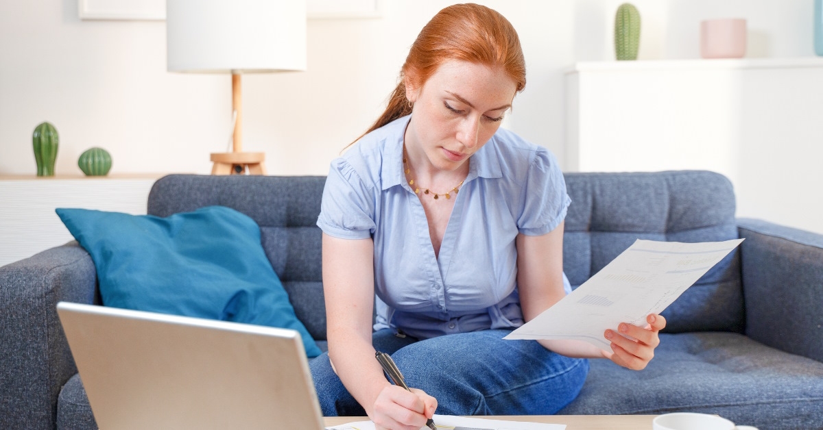 female accountant reviewing bills at home
