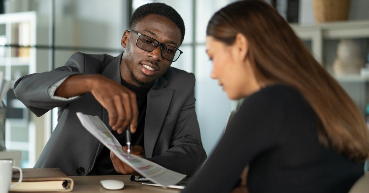 finance advisor reading contract to woman