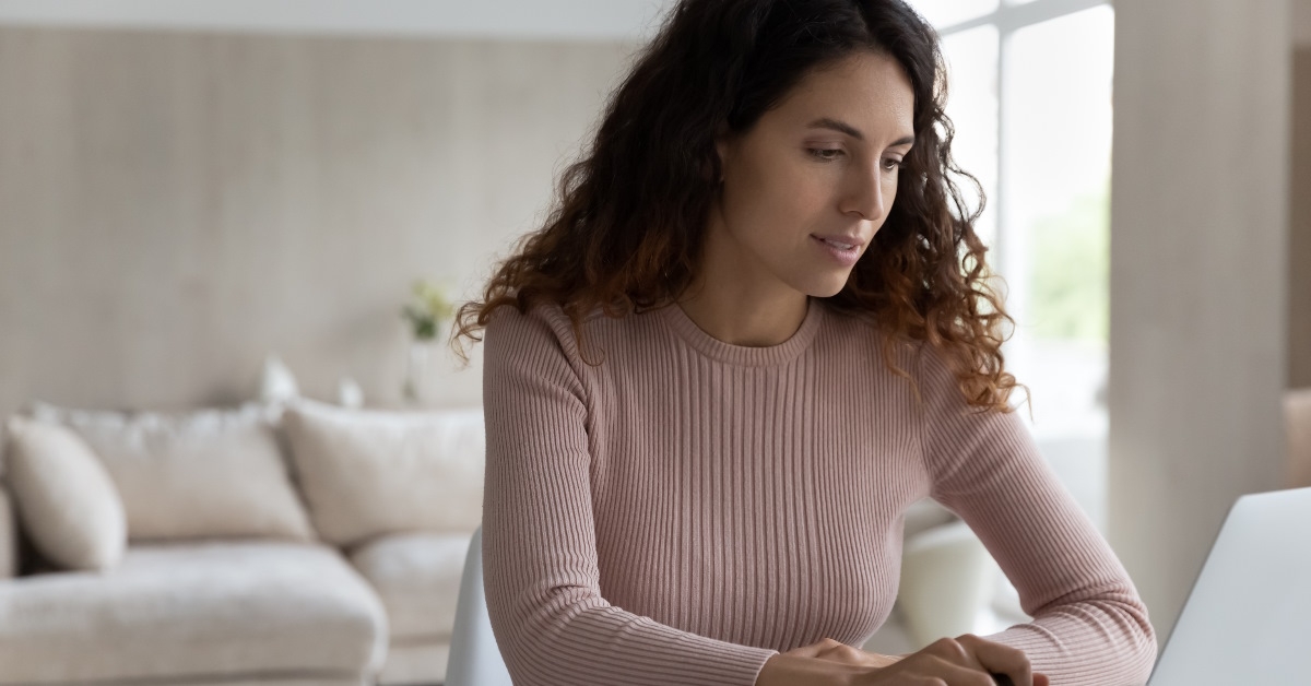 woman reviewing bills using laptop