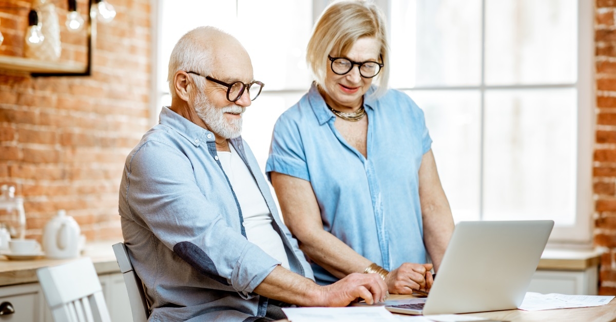 senior couple working together on laptop