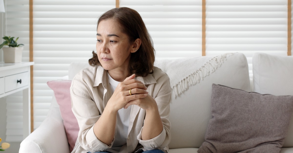 unhappy woman on couch at home