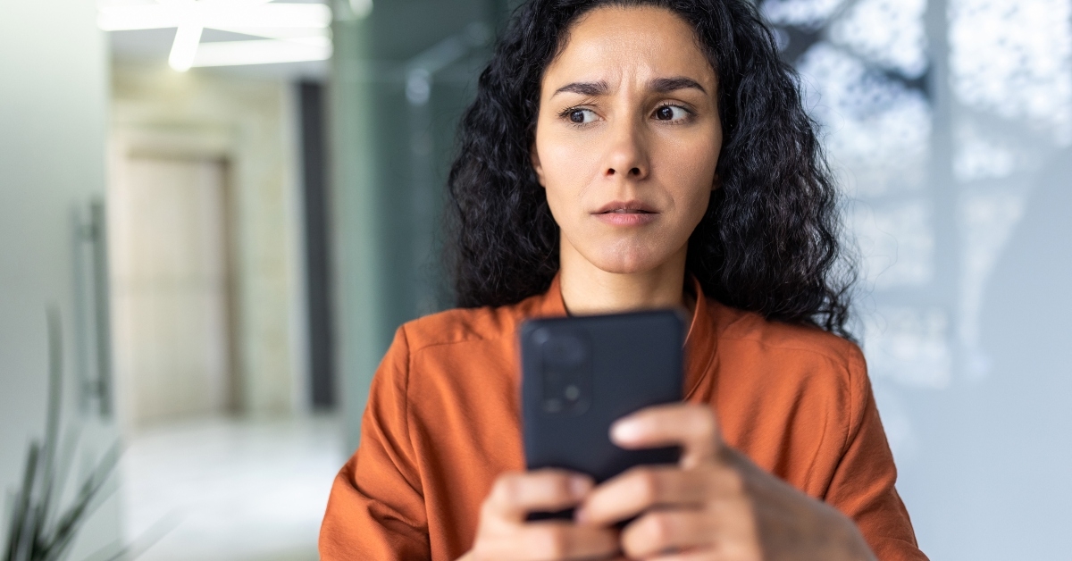woman reading bad news on phone