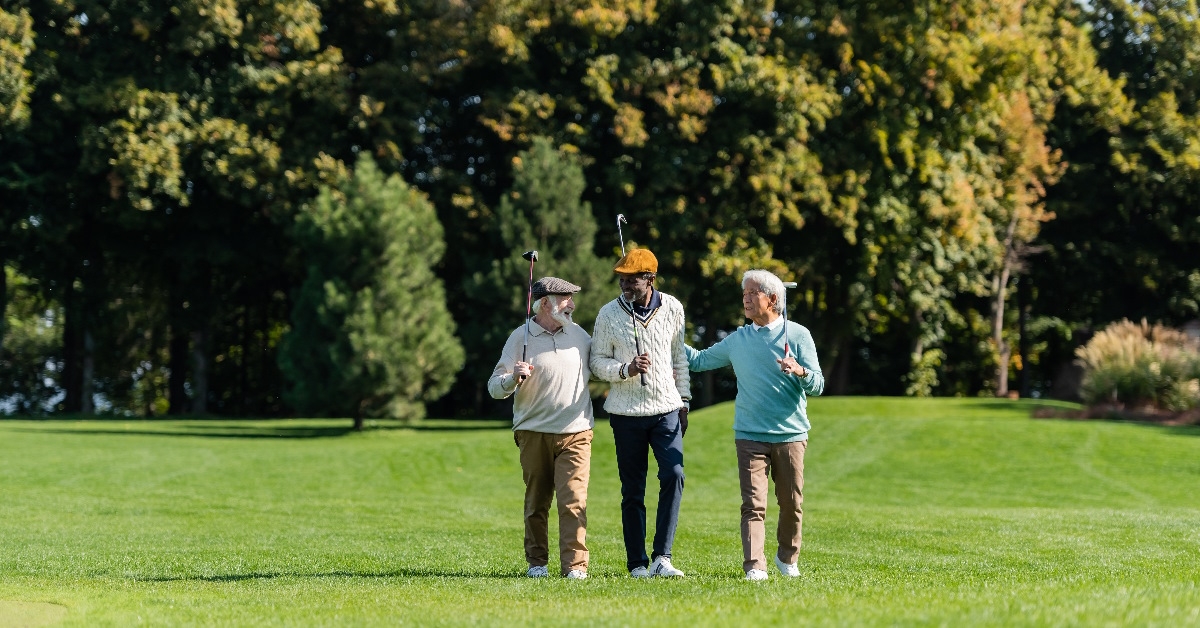 elderly friends on golf course.