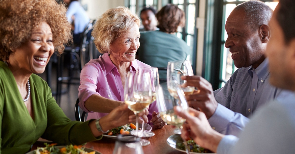 senior friends meeting for a meal in a restaurant.