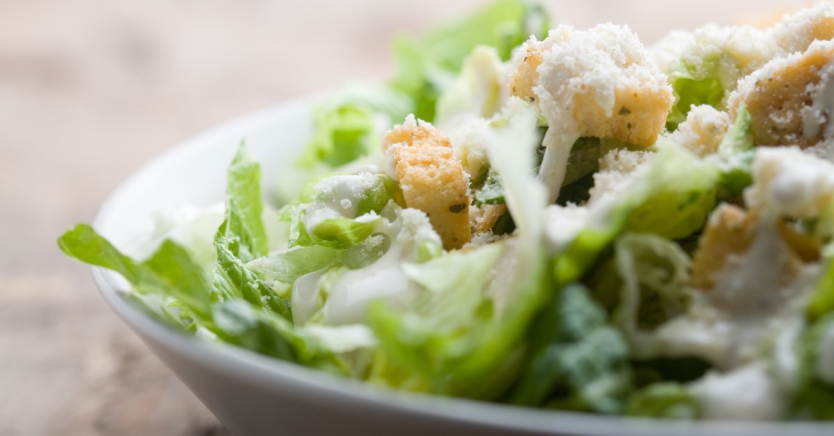 caesar salad bowl on table
