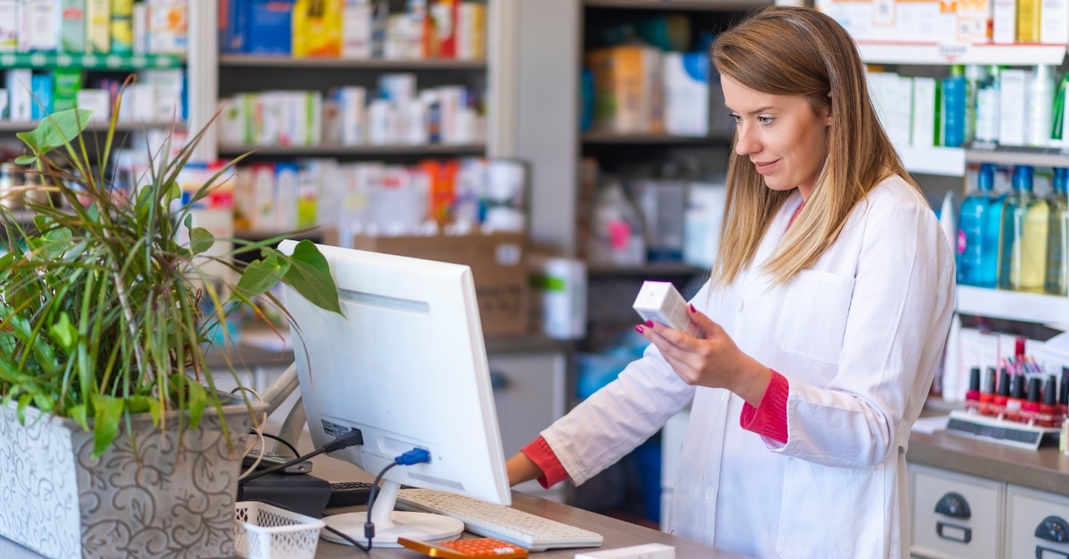 female pharmacist checking medicine on computer