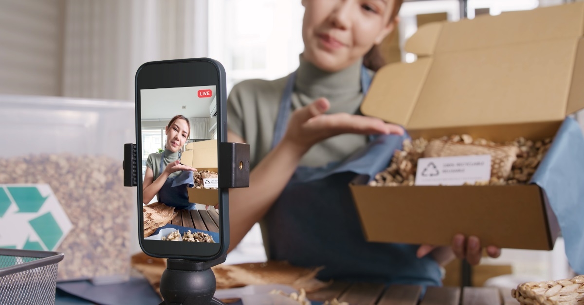 woman unboxing package on live video