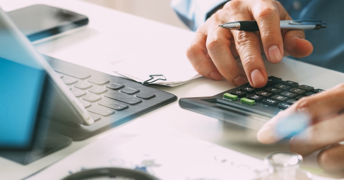 doctor uses a calculator for medical costs