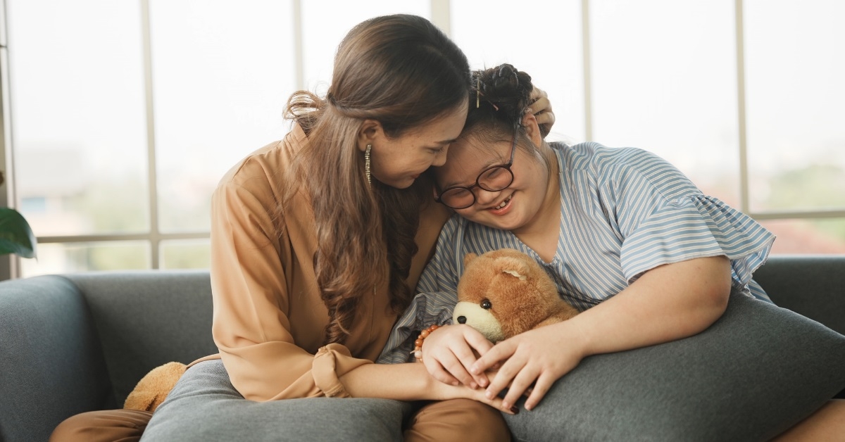 woman hugging down syndrome daughter