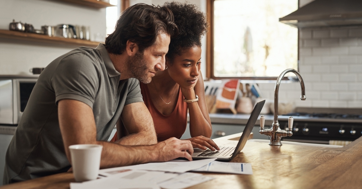 couple financial planning in a kitchen