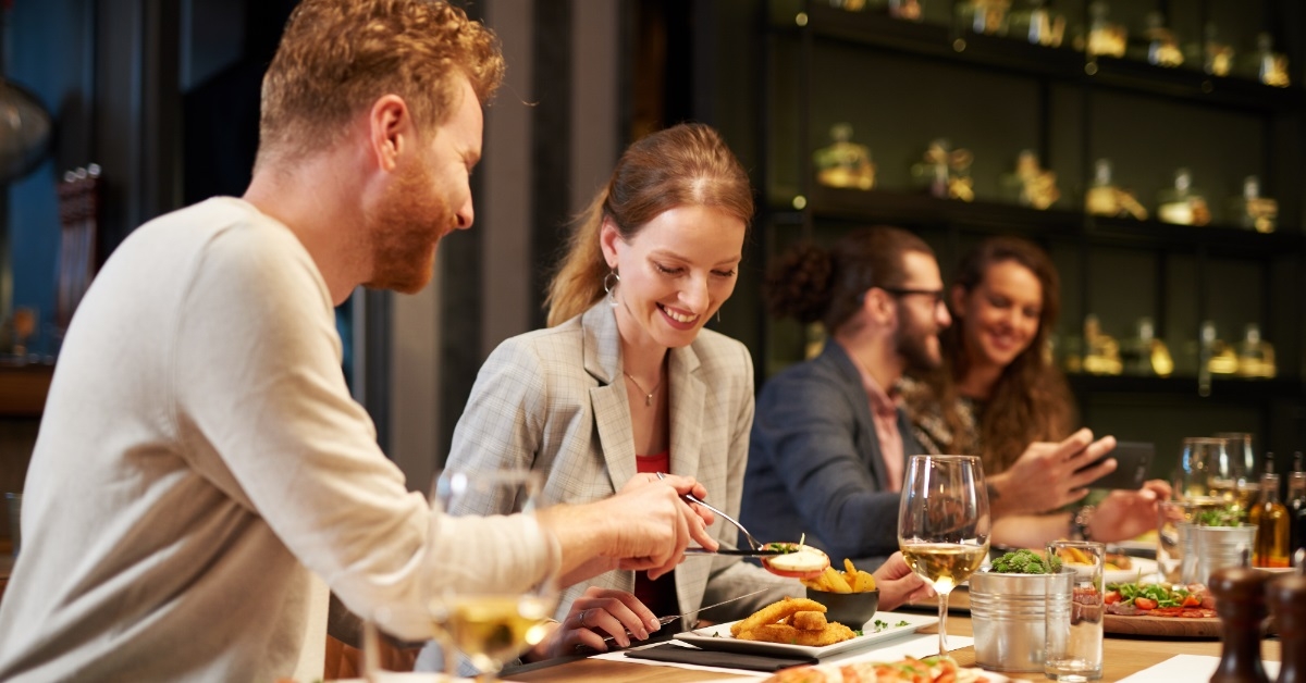 man serving food to girlfriend