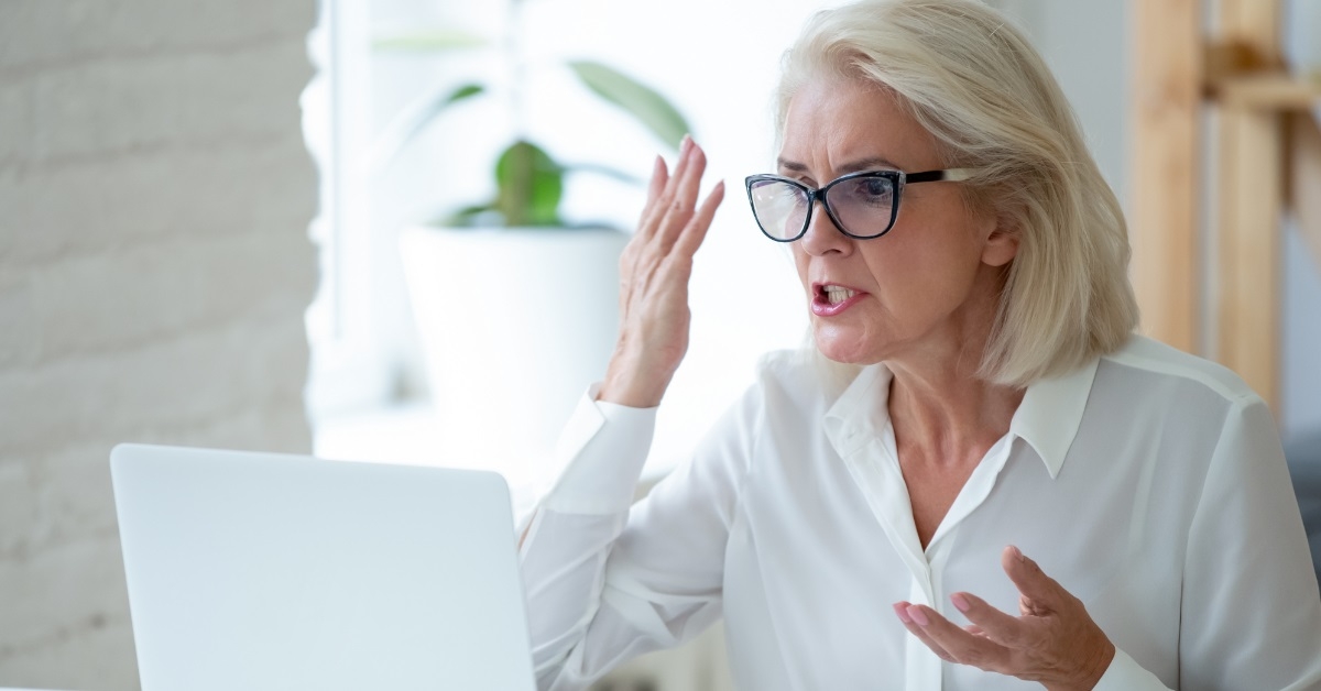 senior business woman frustrated at laptop