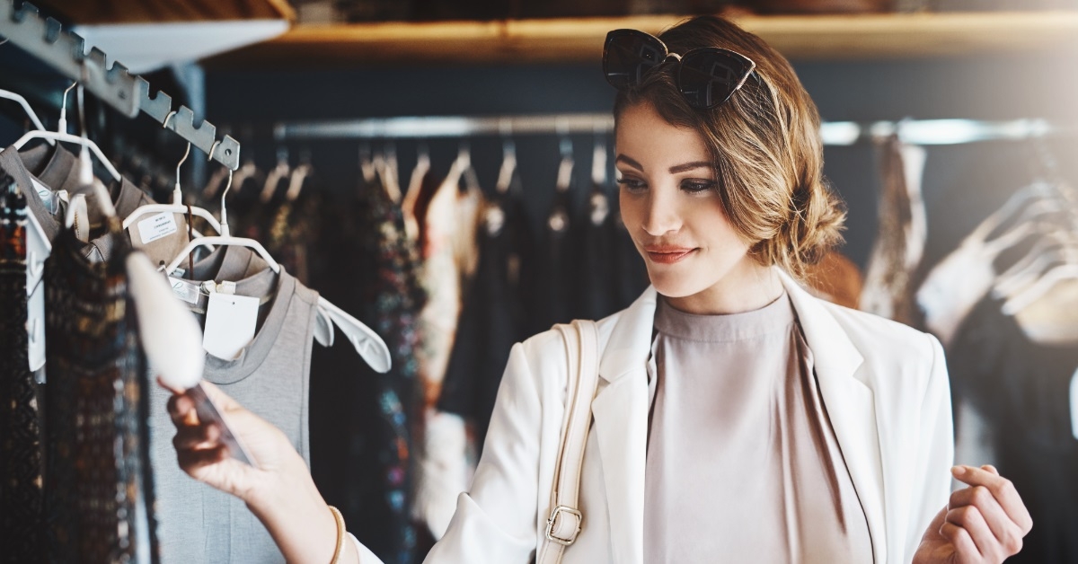 stylish woman checking dresses at boutique