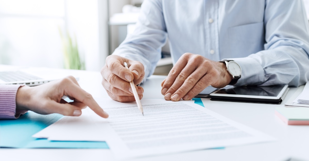 colleagues reviewing contract at work