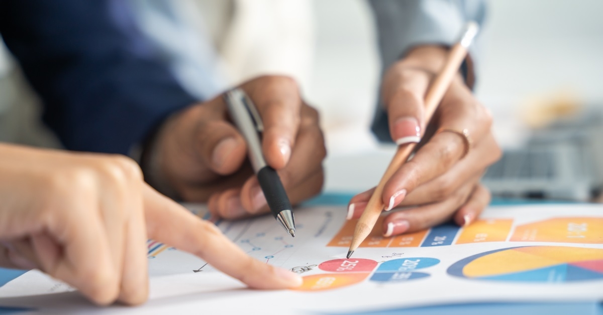 colleagues reviewing business data on graphs