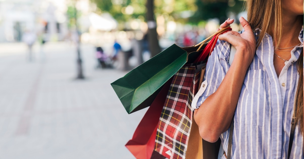 woman holding shopping bags in street 